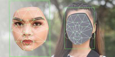 Computer illustration of a deepfake being made - a woman's face is shown being swapped with another face.