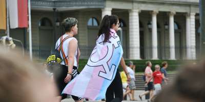Pride parade in Geneva in 2019, woman wearing trans rights flag.
Picture free to use via Unsplash