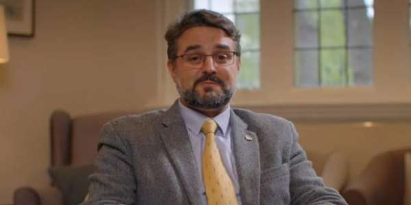 A screenshot from the video, Dr José Pérez Díez smiles to camera.